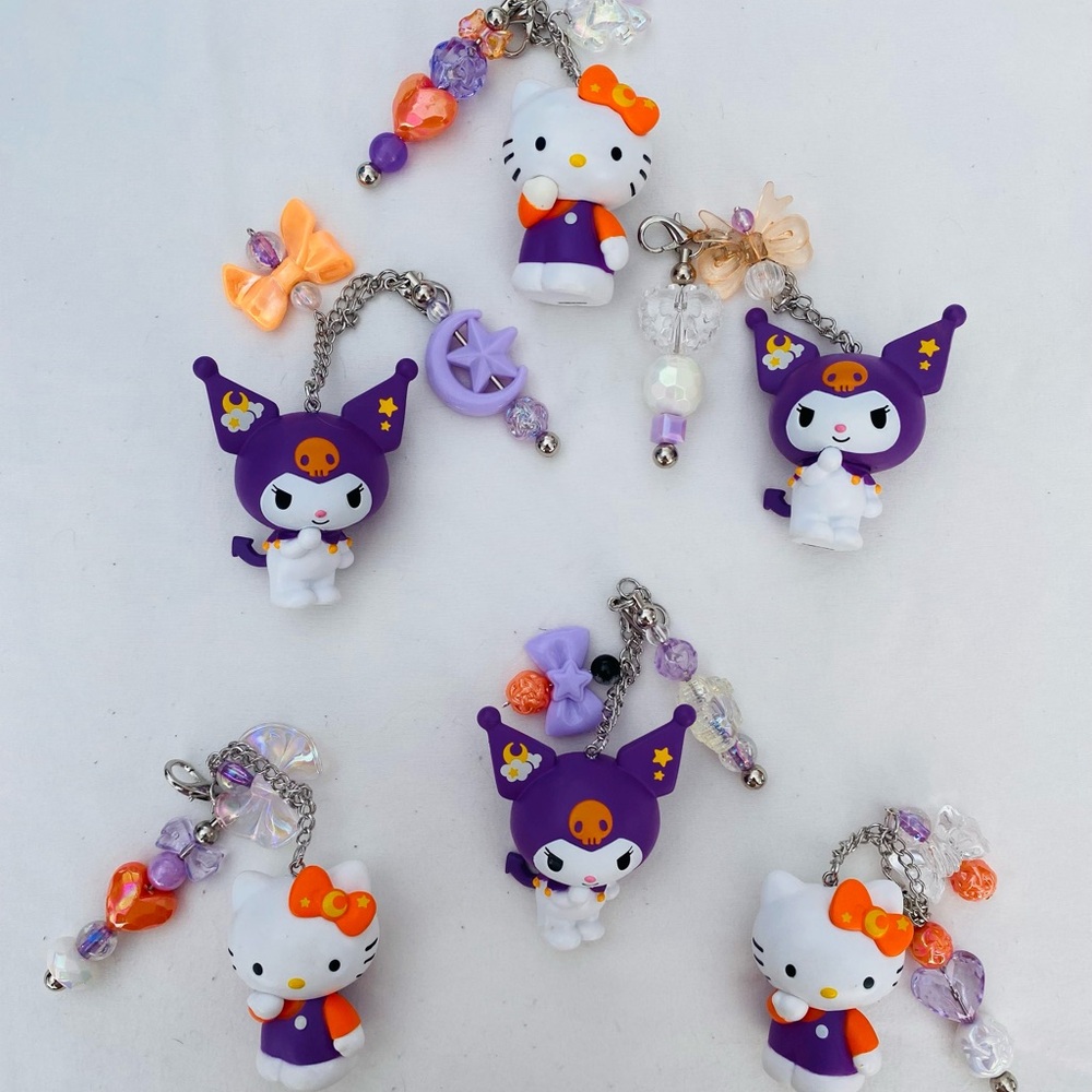 Cute Hello Kitty Character Keychains with Purple and Orange Accents